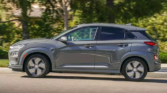 Hyundai Kona Electric - A modern, electric vehicle with a sleek design against a scenic backdrop, showcasing eco-friendly technology and innovation
