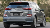 Hyundai Kona Electric - A modern, electric vehicle with a sleek design against a scenic backdrop, showcasing eco-friendly technology and innovation