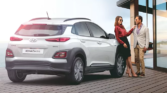 Hyundai Kona Electric - A modern, electric vehicle with a sleek design against a scenic backdrop, showcasing eco-friendly technology and innovation